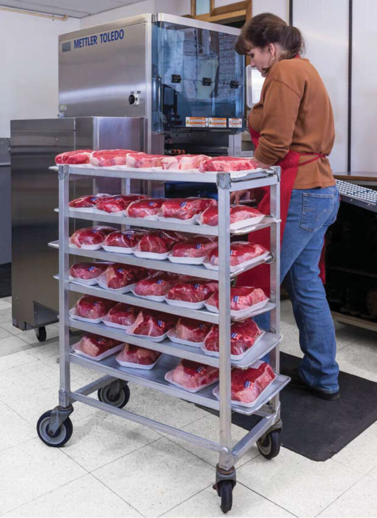 Woman From Hess Meat Machines Taking Out Meat From Mettler Toledo Packaging Machine
